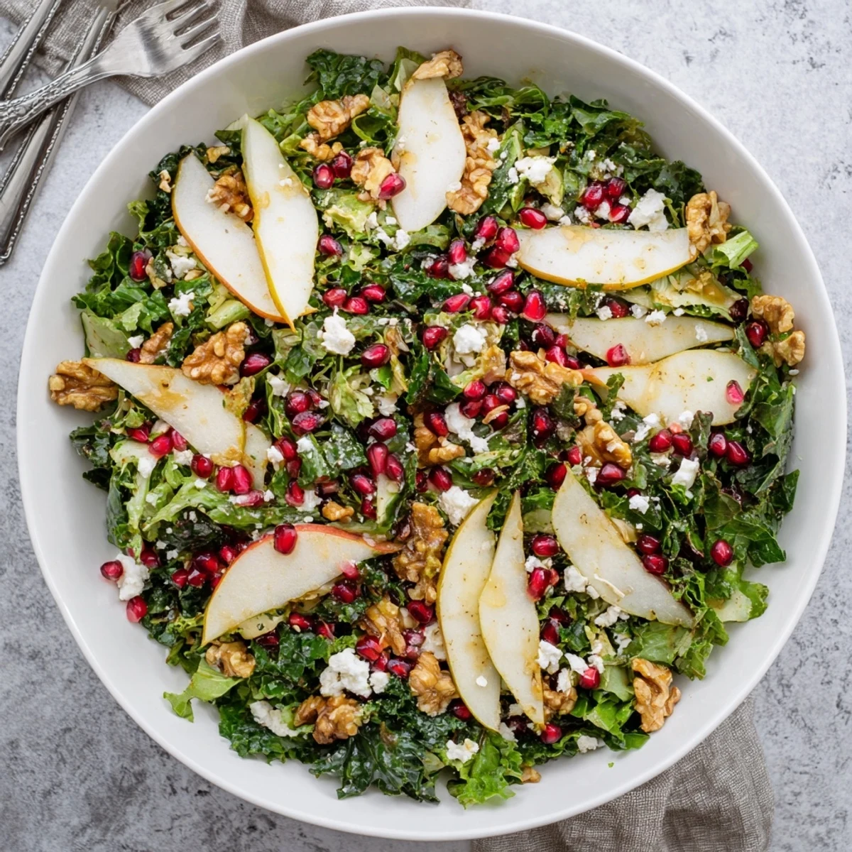 Healthy Winter Green Salad with Pear and Walnuts, featuring glistening greens and golden toasted nuts, served as a light side.