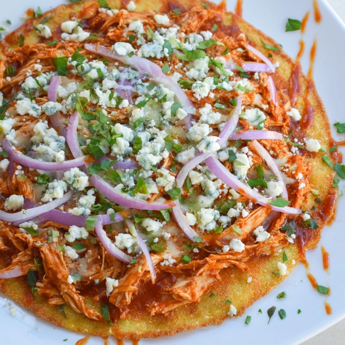 A bubbling MVP Buffalo Chicken Pizza fresh from the oven, topped with green onions and parsley.