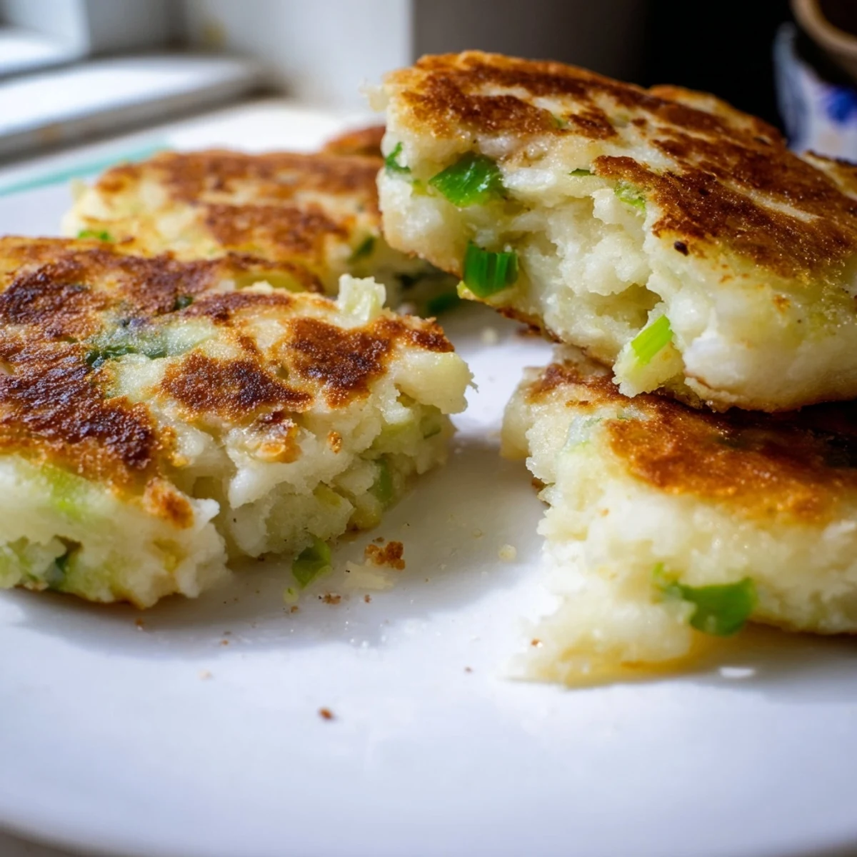Golden-brown Irish Potato Cakes with Scallions, fresh from a hot skillet, served with melting butter.