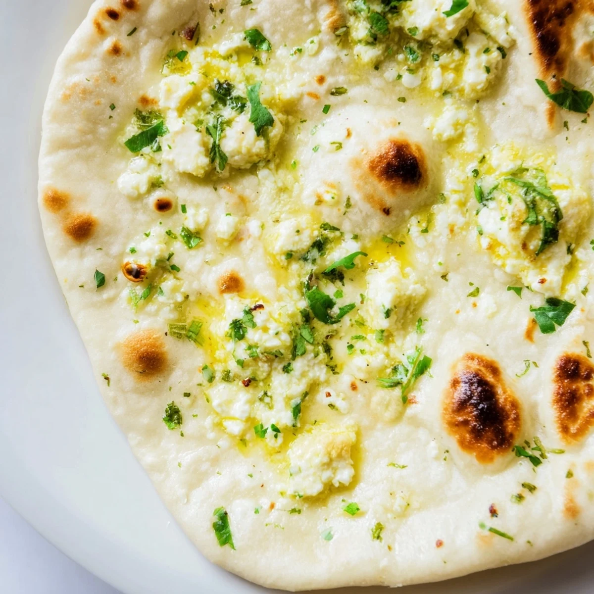 Golden-brown Cottage Cheese Garlic Naan fresh from a hot cast-iron skillet, brushed with melted garlic butter.  