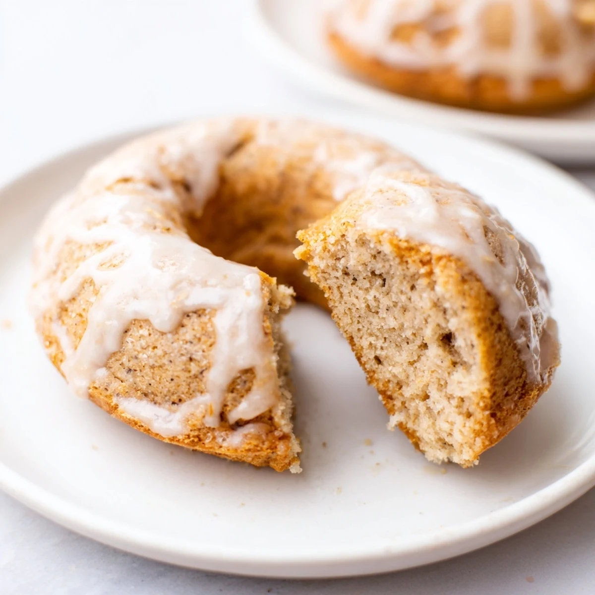 Stacked golden Baked Banana Bread Donuts with moist texture, perfect as a snack or dessert.