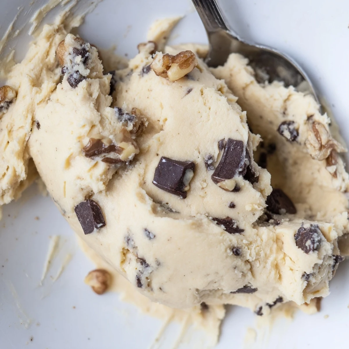 Guilt Free Greek Yogurt Cookie Dough in a white bowl, showing creamy texture and mini chocolate chips.