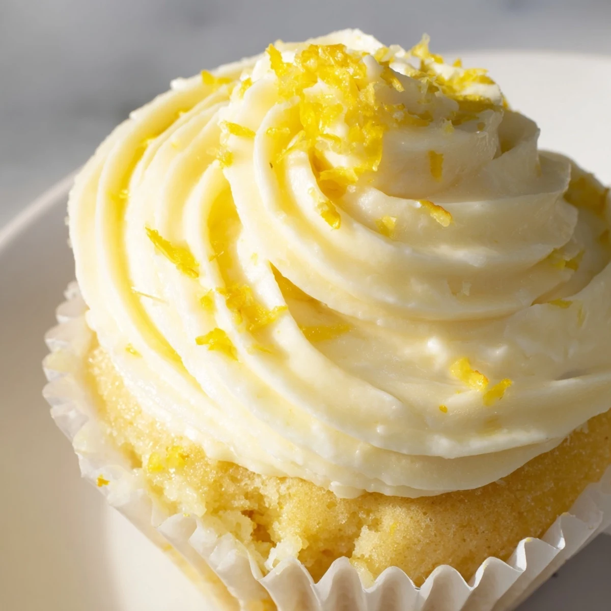 Freshly baked Limoncello Cupcakes topped with fluffy lemon buttercream frosting.