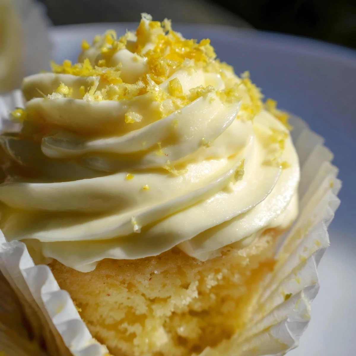 Soft Limoncello Cupcakes displayed on a wire rack after baking.