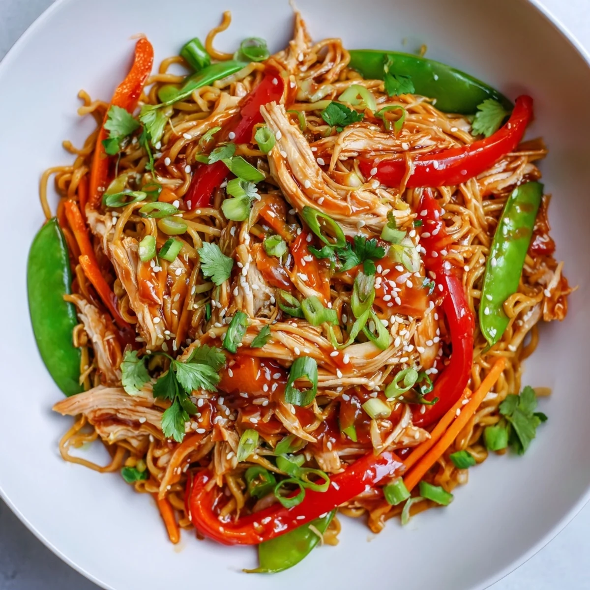Family-style Sweet Chilli Turkey Noodle Stir Fry served steaming hot from the wok, garnished with spring onions and fresh coriander.