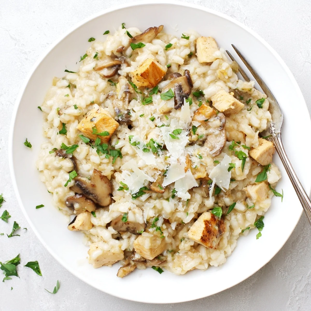 Oven-baked chicken and mushroom risotto with white wine, herbs, and creamy Parmesan sauce