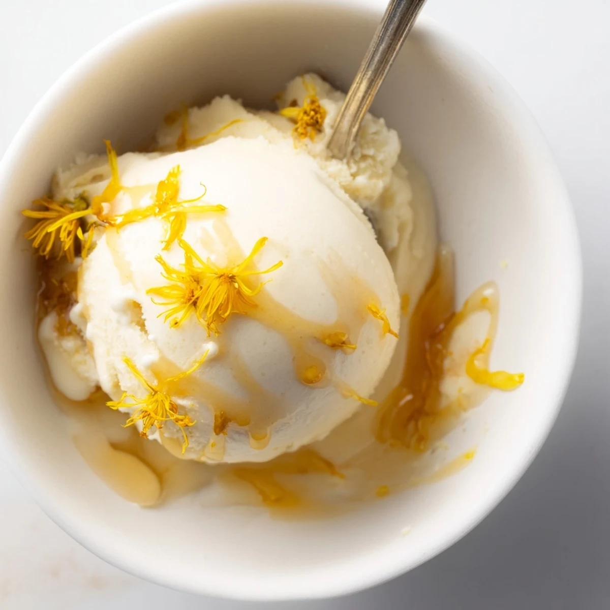 Homemade dandelion honey ice cream in a chilled bowl ready for spring dessert