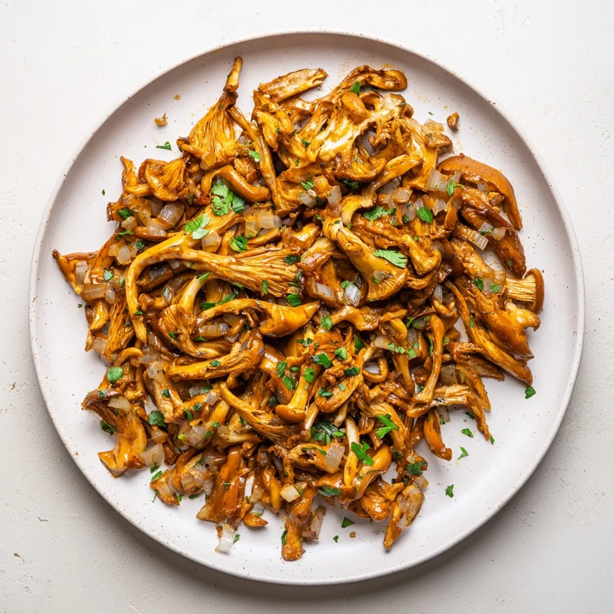 Spicy plant-based mushroom carnitas topped with fresh cilantro and diced red onion