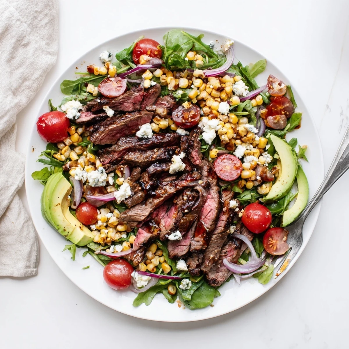 Juicy grilled steak over crisp greens topped with crumbled gorgonzola and grilled corn