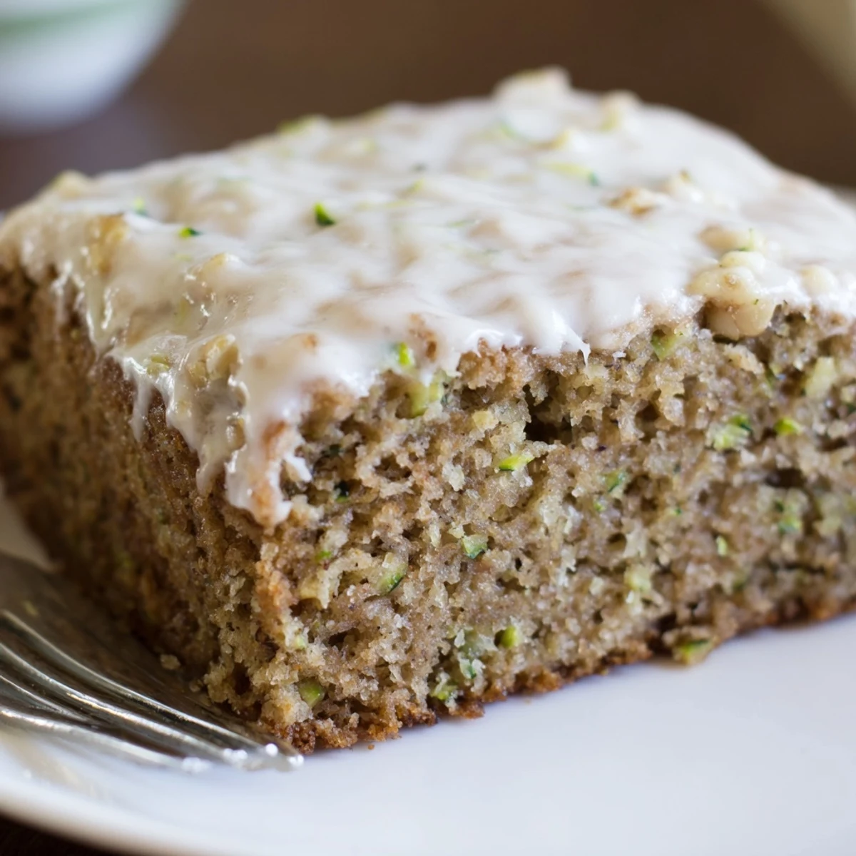 Warm, moist Zucchini Cake With Brown Sugar Icing topped with toasted pecans  