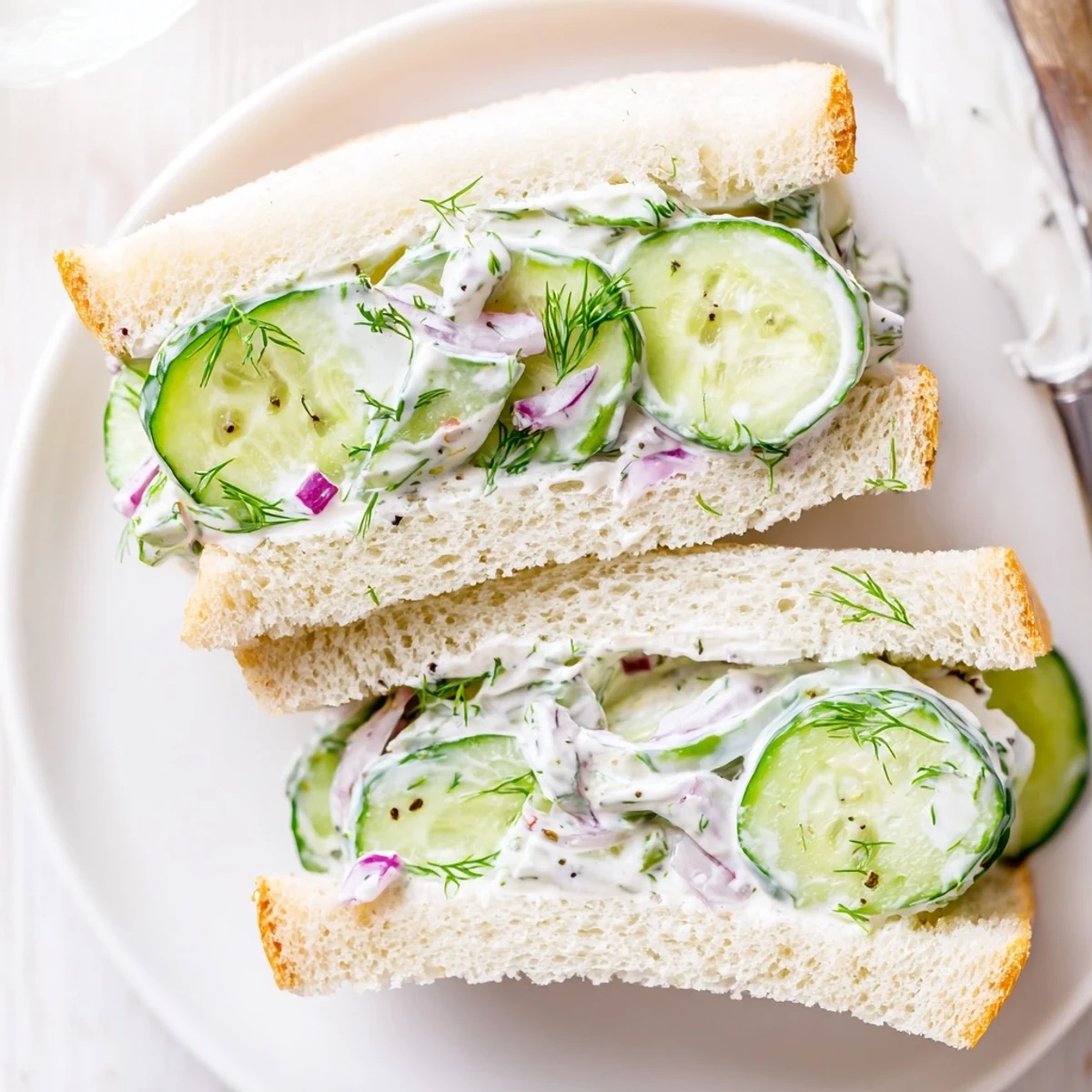 Light Quick Cucumber Salad Sandwiches served halved, crisp cucumber and onion visible