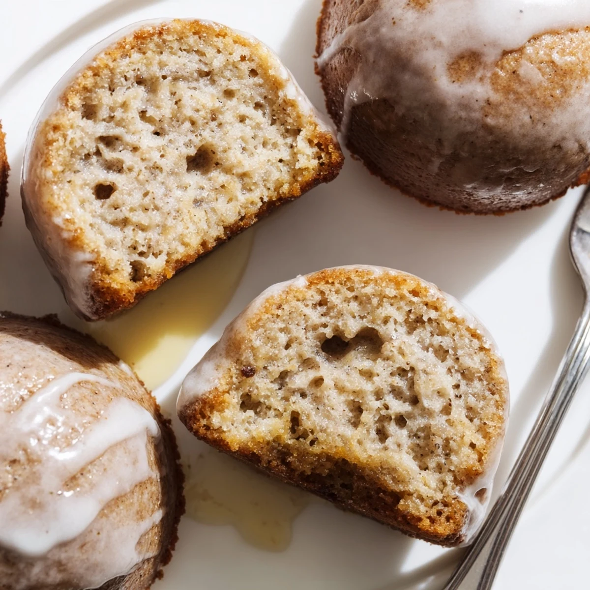 Banana Donuts with glossy vanilla glaze, golden edges and fluffy cake interior