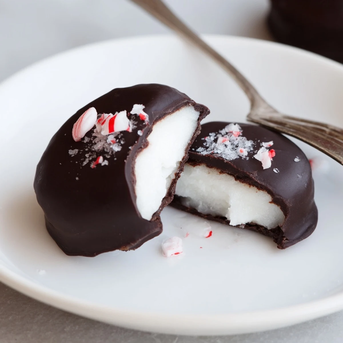 Peppermint Patties with glossy dark chocolate, cool mint filling chilled on parchment
