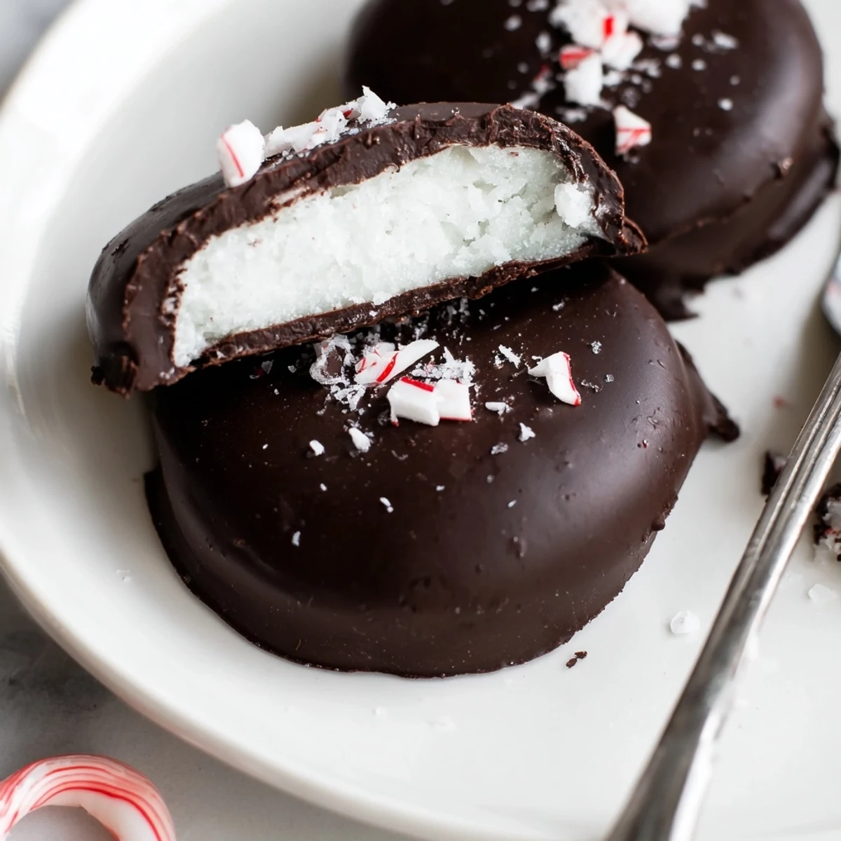 Hand-dipped Peppermint Patties cooling on rack, glossy coating and mint aroma