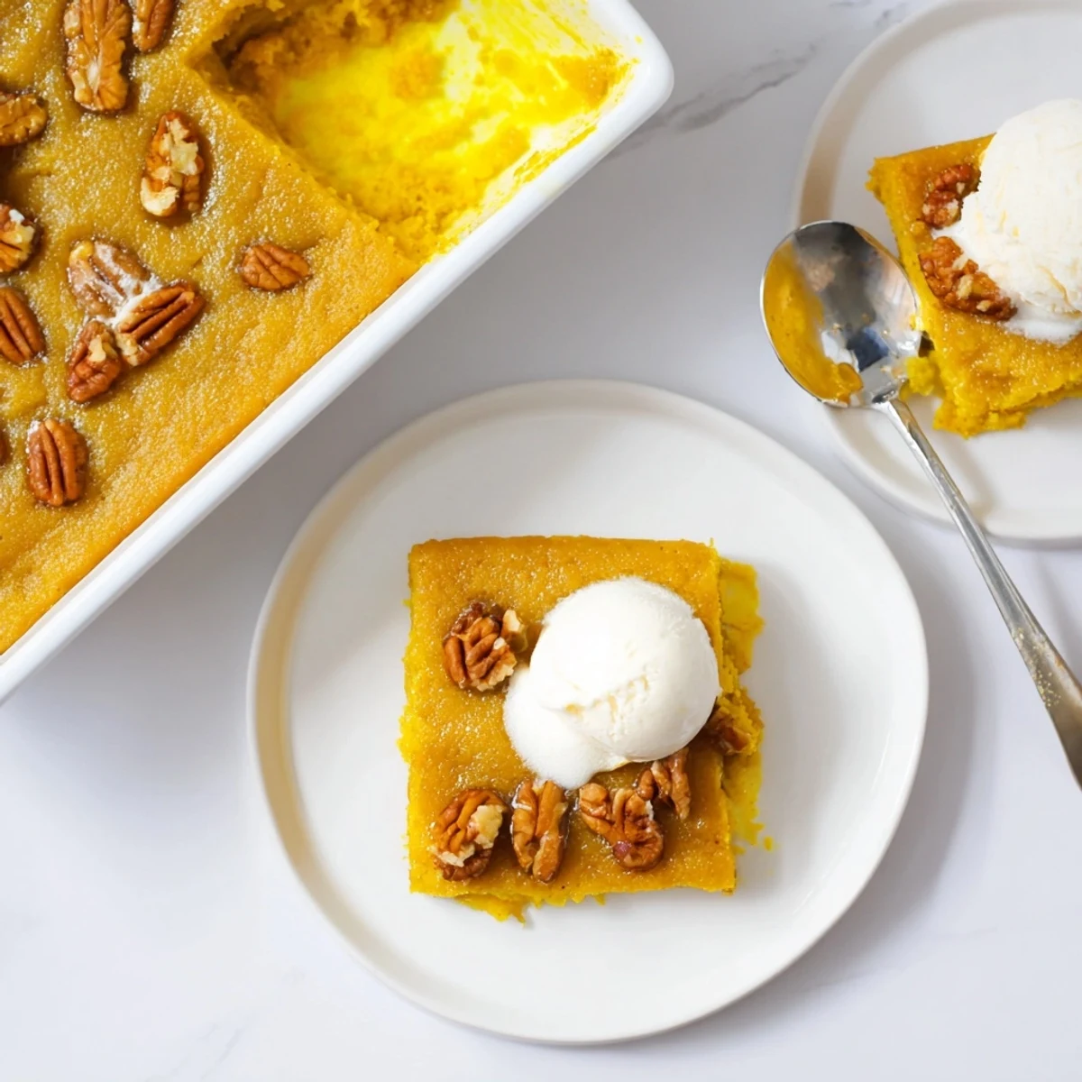 Slice of Pumpkin Dump Cake on plate, silky spiced filling, whipped cream
