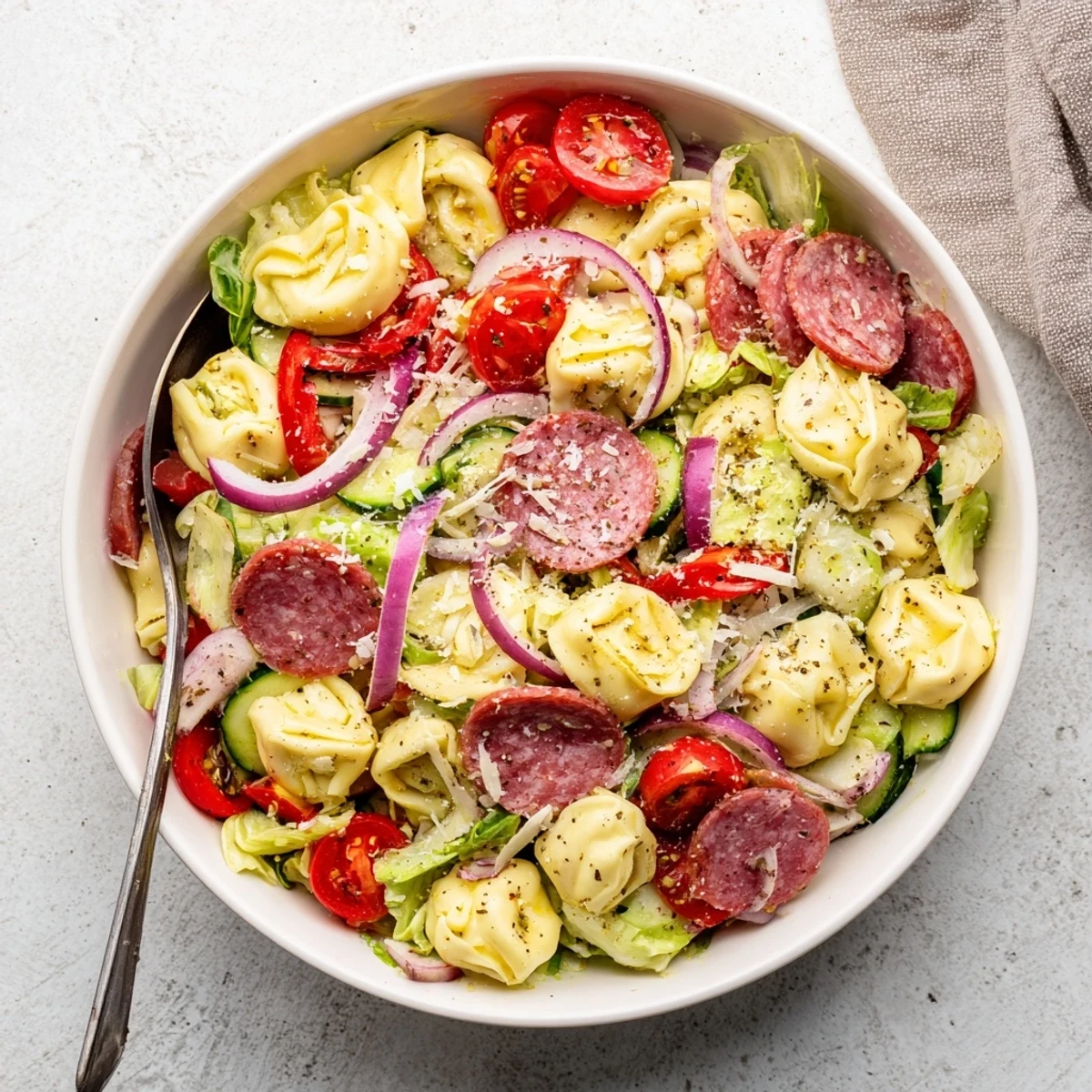 Colorful bowl of fresh grinder tortellini salad recipe loaded with vegetables and provolone