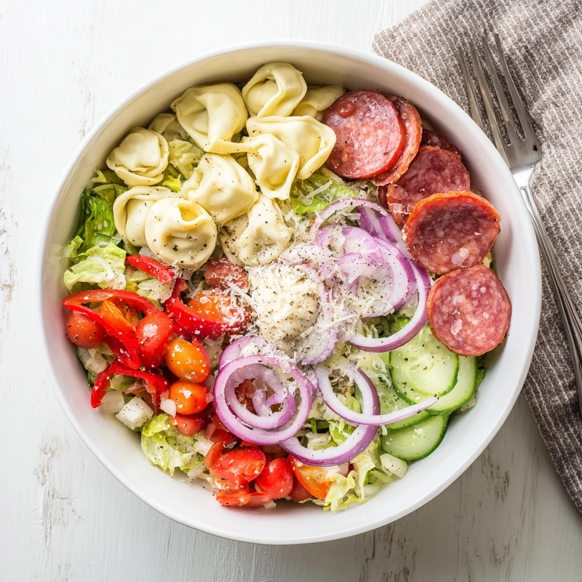 Vibrant Italian-inspired grinder tortellini salad recipe with cherry tomatoes and cubed provolone cheese