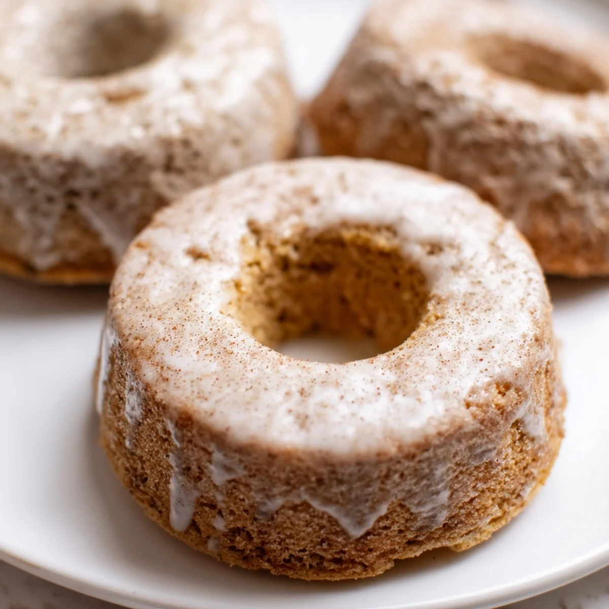 Freshly baked banana bread donuts arranged on a rustic wooden serving board
