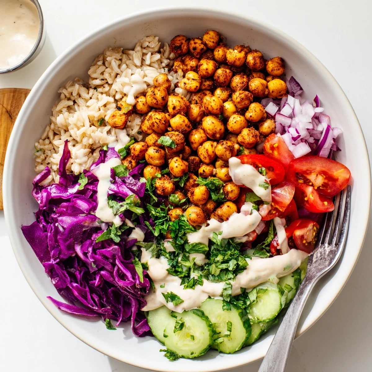 Golden crispy spiced chickpeas top this vibrant chickpea shawarma bowl with creamy tahini drizzle